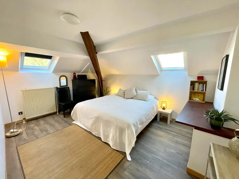 Bedroom 1 with tree-of-life painting and bedside lamps